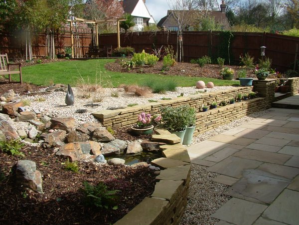 garden design York stone planted risers to woodland style plants and small water course